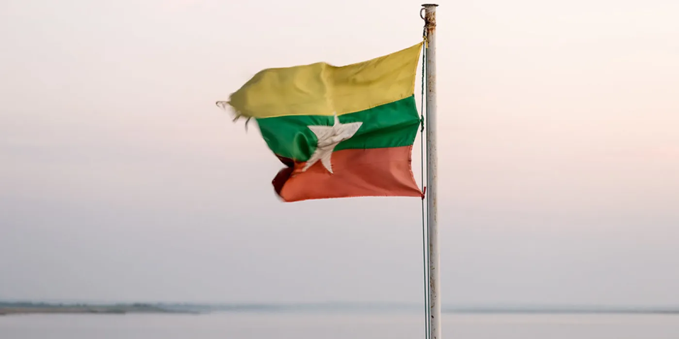 "Burmese flag on a Irrawaddy River boat fluttering in the wind" by thaths is licensed under CC BY-NC 2.0.